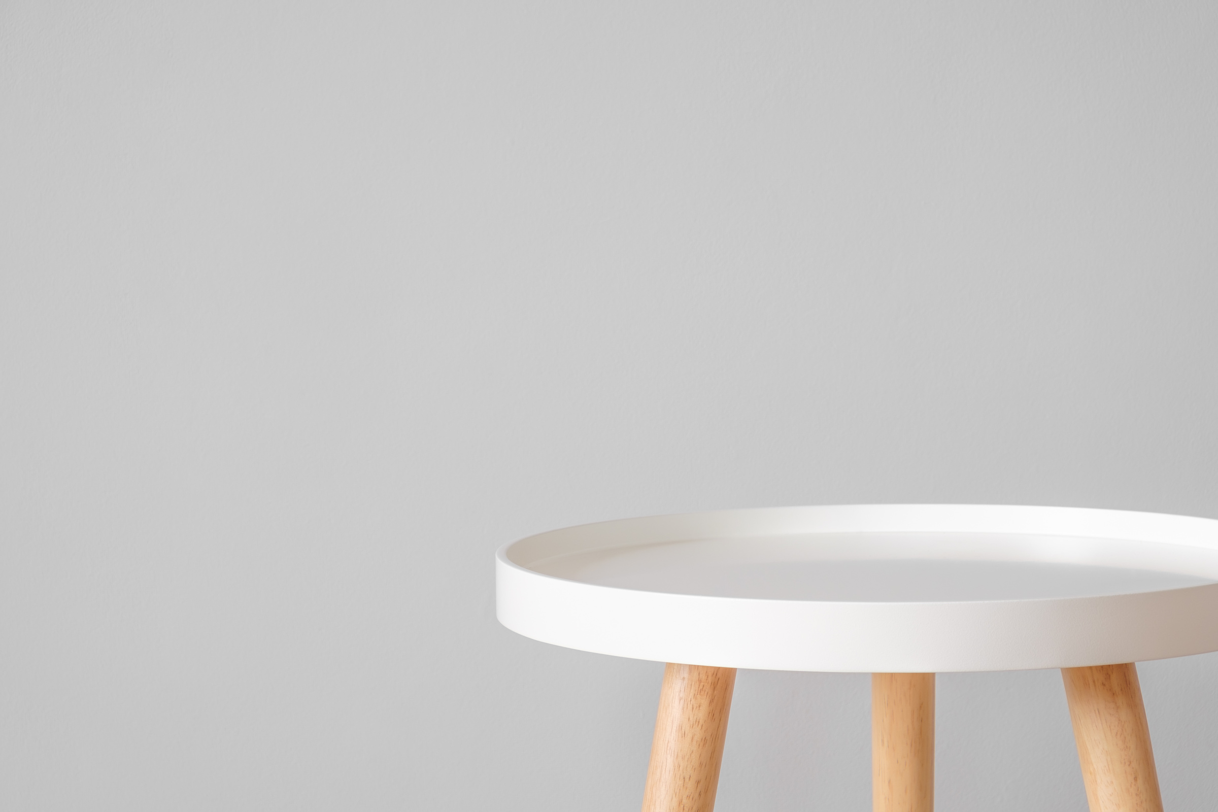 Empty White Coffee Table in Front of Grey Wall